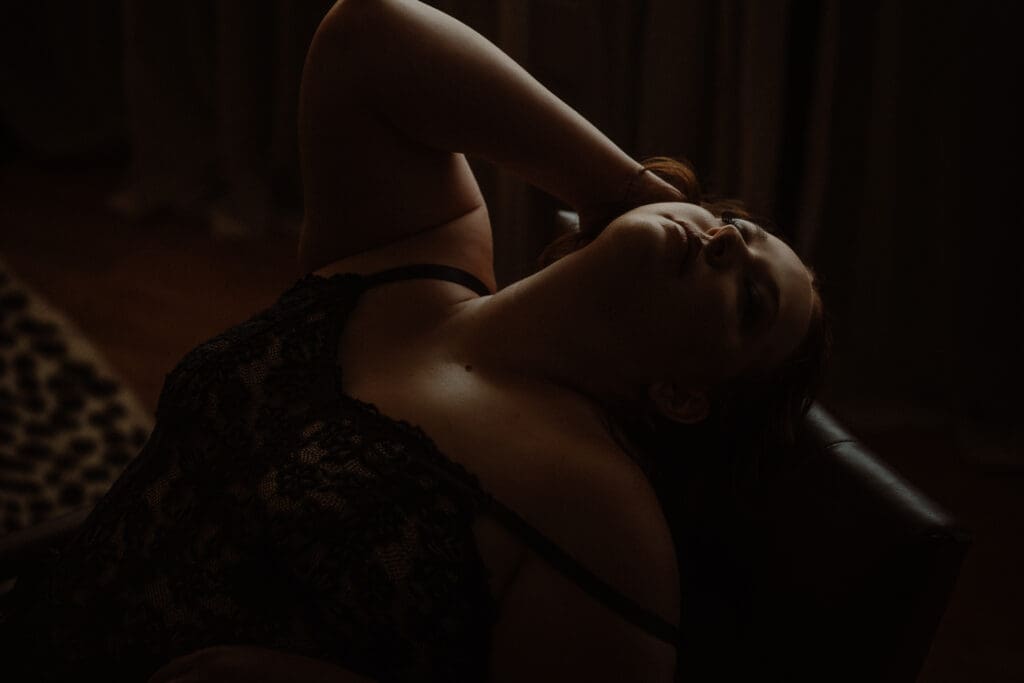 Woman posing confidently during a guided boudoir photoshoot showing intentional posing direction at Onyx and Sage Studios