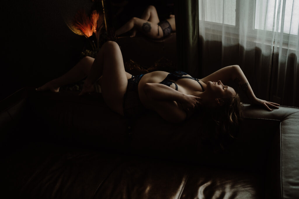 Woman embracing confidence during a boudoir photography session focused on body positivity and self expression.