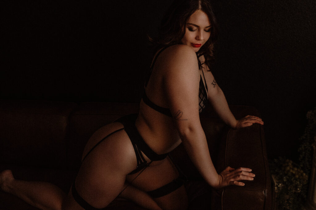 boudoir client in The Onyx Haus confidently posing during session highlighting embodiment and self confidence