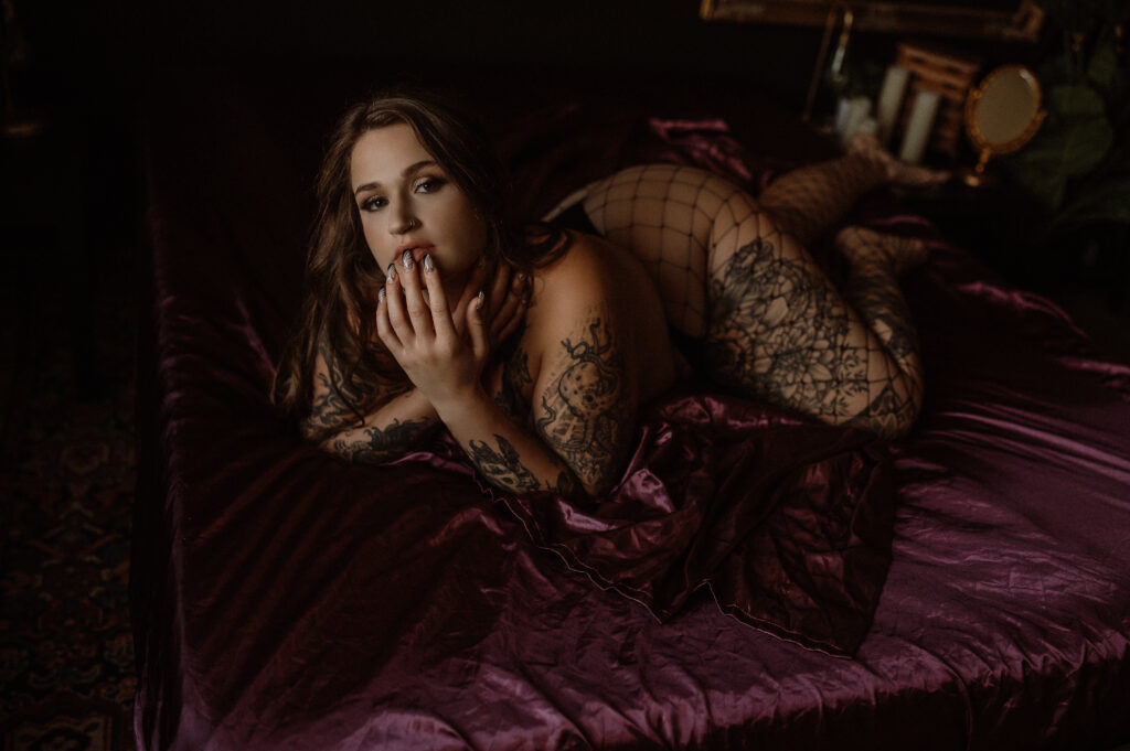 Confident woman photographed in a luxury boudoir portrait session highlighting body confidence and feminine presence.