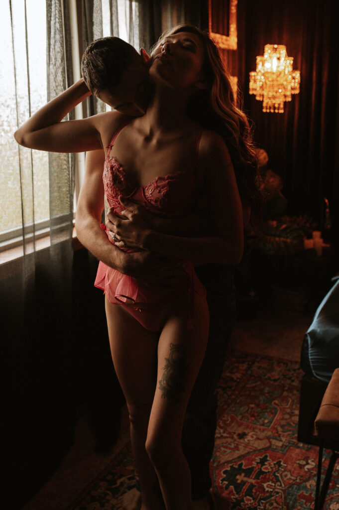 partner holding woman intently by the waist, showing control, connection, and embodied sensuality