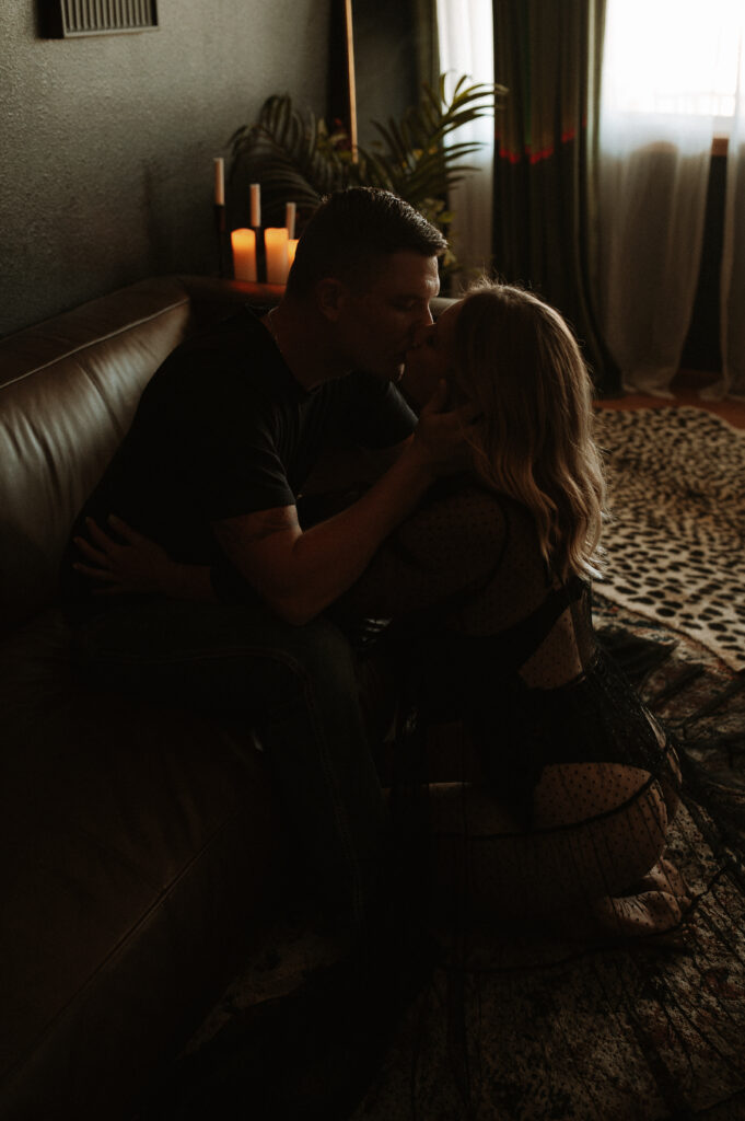 couple sharing a kiss during intimate photo session capturing emotional and physical connection